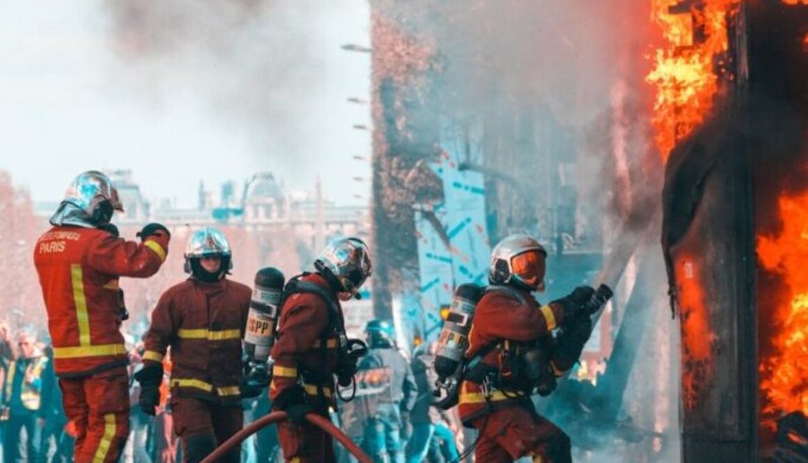 firemen working on building on fire